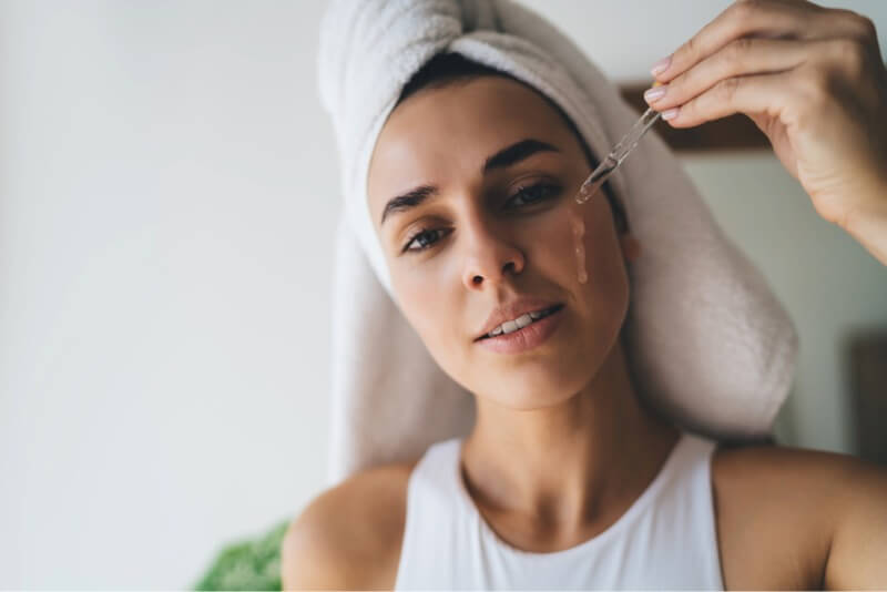 Woman putting product on her face