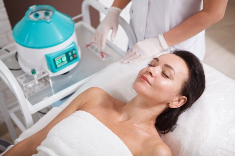 Woman laid down awaiting her vampire facial